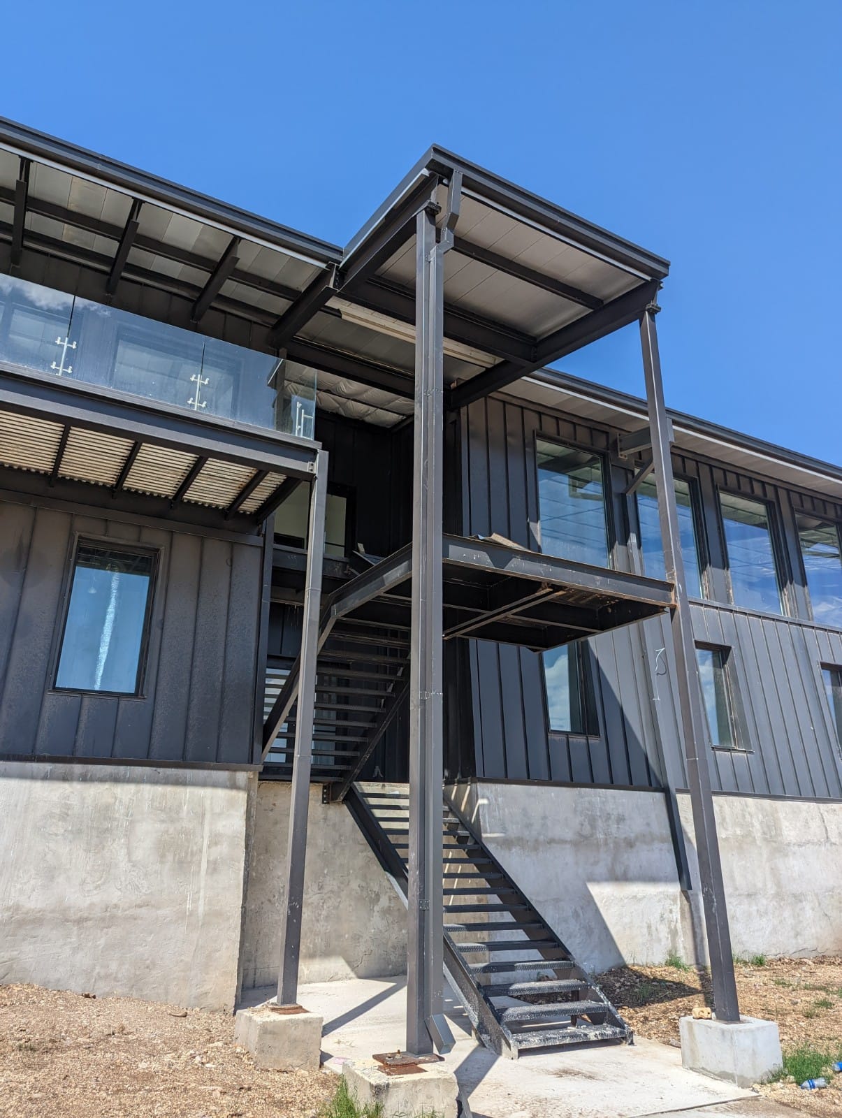 Custom-fabricated industrial steel staircase with landing